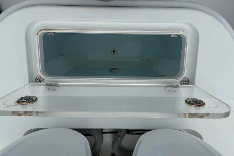  Yacht Photos Pics Open storage compartment on 2015 Yellowfin 32 boat, featuring a transparent lid and clean interior.
