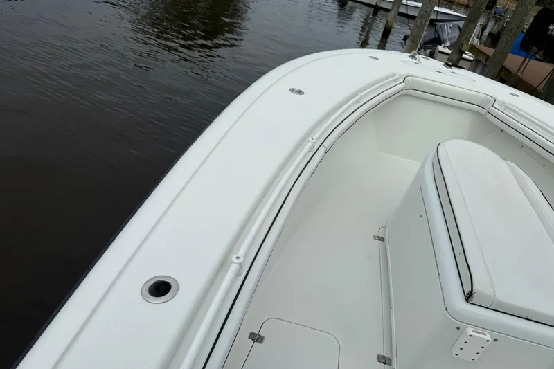  Yacht Photos Pics 2015 Yellowfin 32 boat interior, featuring sleek white seating and spacious deck.