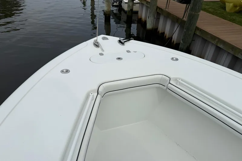  Yacht Photos Pics 2015 Yellowfin 32 boat bow with white seating and dock view.