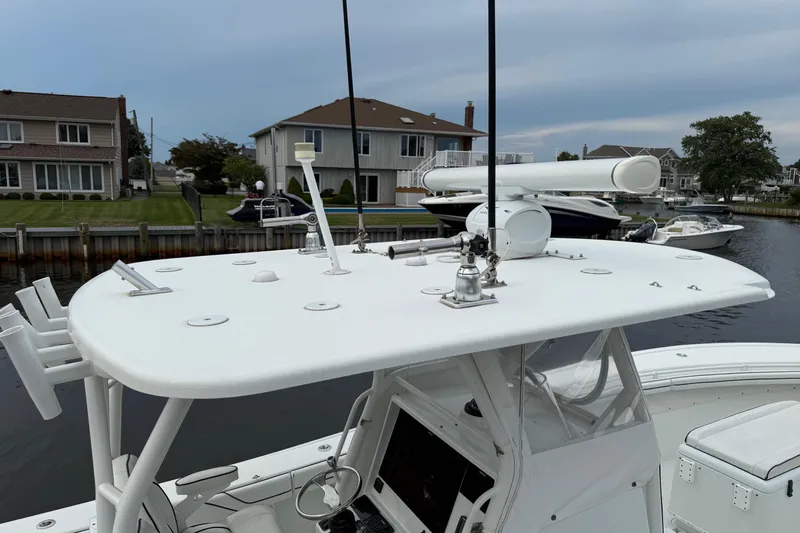  Yacht Photos Pics 2015 Yellowfin 32 boat with radar and antennas docked near waterfront homes.