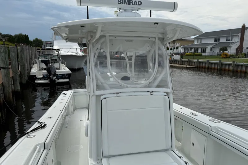  Yacht Photos Pics 2015 Yellowfin 32 boat docked in a marina, featuring a sleek white design.