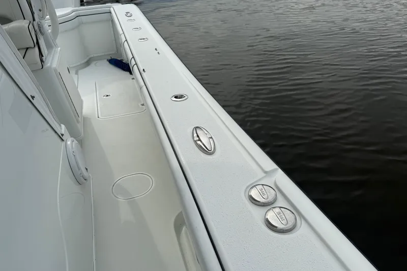  Yacht Photos Pics 2015 Yellowfin 32 boat deck with rod holders, near calm water.