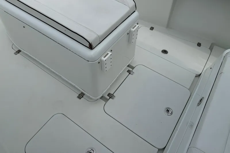  Yacht Photos Pics 2015 Yellowfin 32 boat interior with white seating and storage compartments.