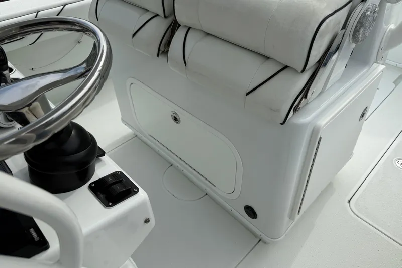  Yacht Photos Pics 2015 Yellowfin 32 boat interior with steering wheel and cushioned seating.