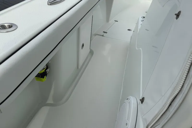  Yacht Photos Pics 2015 Yellowfin 32 boat interior, featuring sleek white deck and storage compartments.