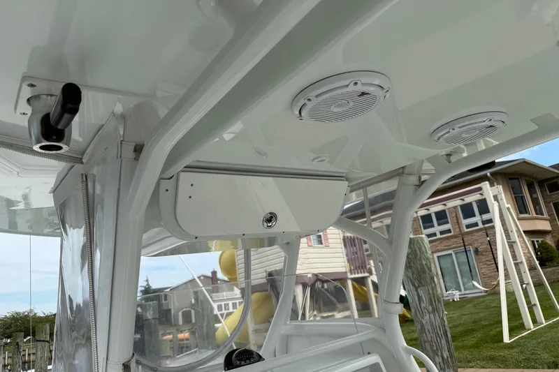  Yacht Photos Pics 2015 Yellowfin 32 boat interior with speakers and storage compartment.