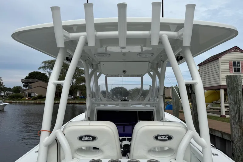  Yacht Photos Pics 2015 Yellowfin 32 boat with T-top and dual helm seats docked by waterfront homes.