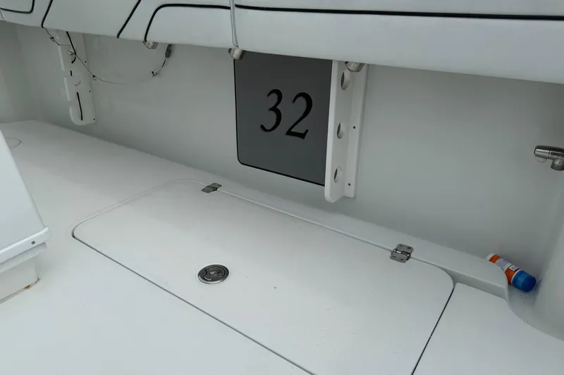  Yacht Photos Pics 2015 Yellowfin 32 boat interior with storage compartment and number 32 displayed.