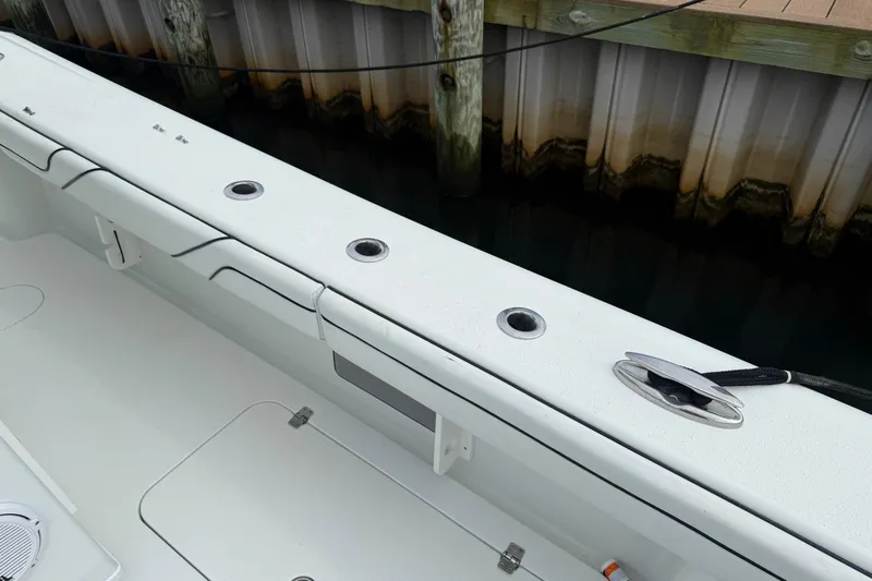  Yacht Photos Pics 2015 Yellowfin 32 boat interior with rod holders and cleat by dock.