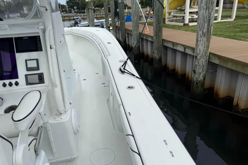  Yacht Photos Pics 2015 Yellowfin 32 boat docked, featuring a sleek white interior and advanced navigation controls.