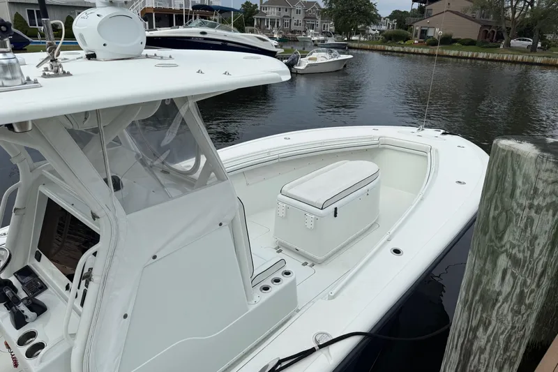  Yacht Photos Pics 2015 Yellowfin 32 boat docked in a marina, featuring a spacious deck and seating area.
