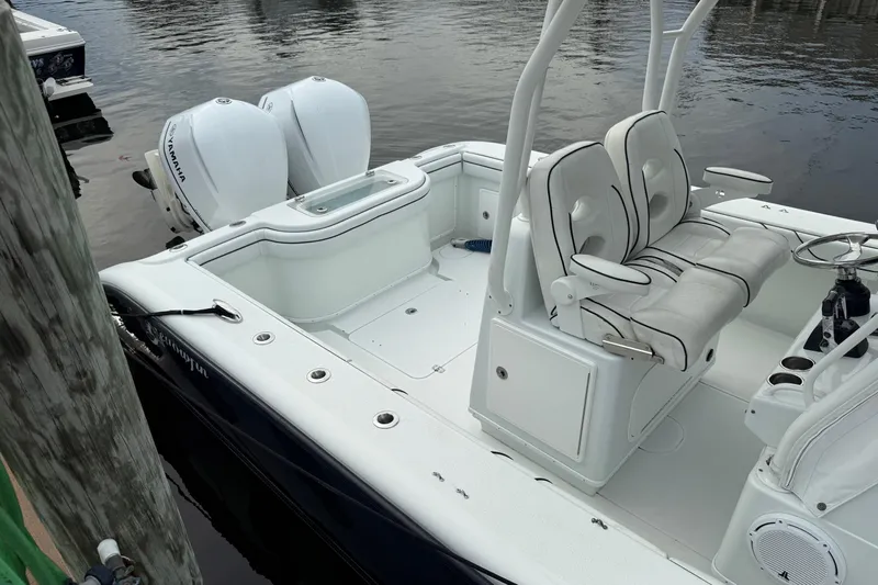  Yacht Photos Pics 2015 Yellowfin 32 boat with twin Yamaha engines docked by the water.