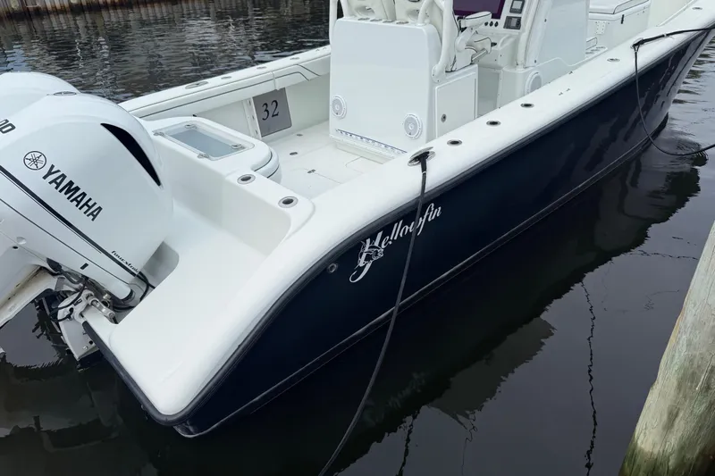  Yacht Photos Pics 2015 Yellowfin 32 boat with Yamaha engine docked in calm waters.