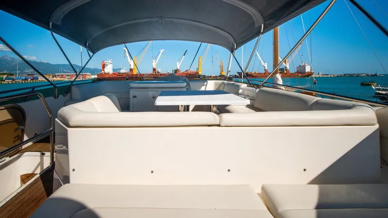  Yacht Photos Pics Flybridge seating area on 2010 Princess 62 yacht with harbor view.