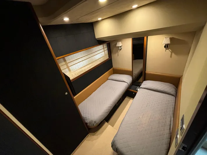  Yacht Photos Pics Twin cabin interior of 2010 Princess 62 Flybridge yacht, featuring modern design and cozy lighting.