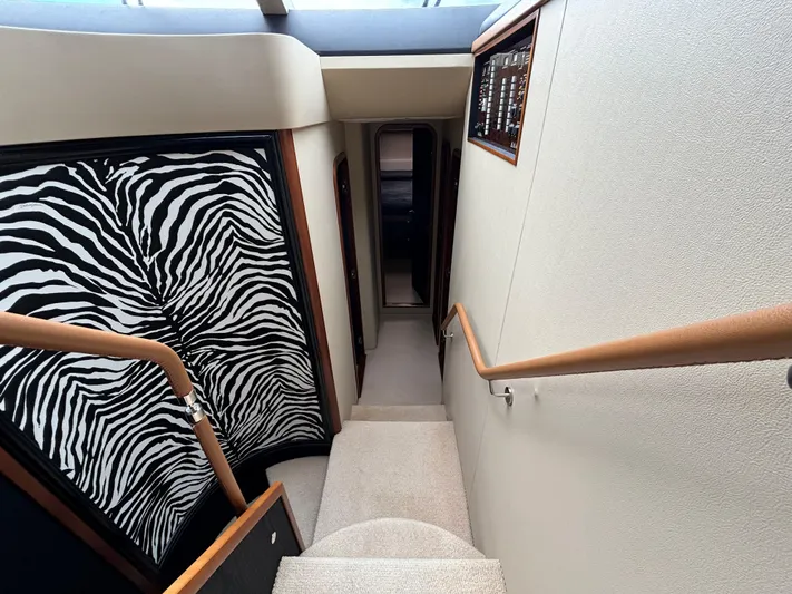  Yacht Photos Pics Staircase interior of 2010 Princess 62 Flybridge yacht with zebra-patterned wall.