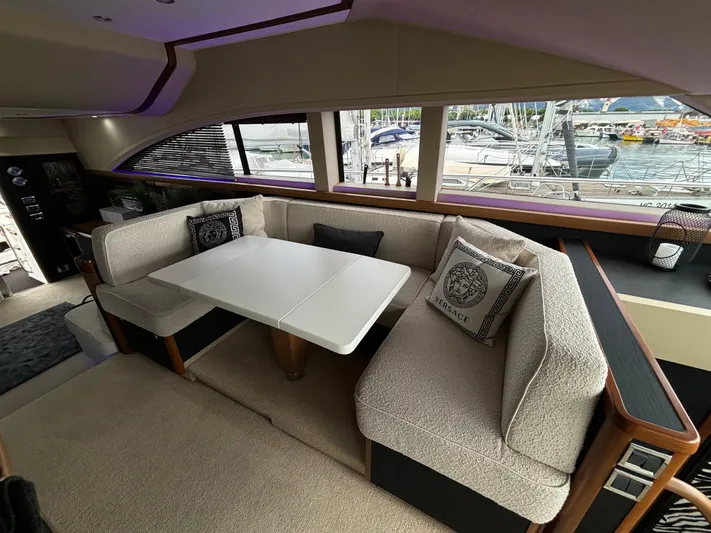  Yacht Photos Pics Luxurious interior of 2010 Princess 62 Flybridge yacht with elegant seating and dining area.