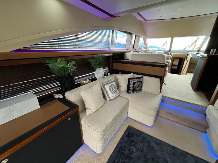  Yacht Photos Pics Luxurious interior of a 2010 Princess 62 Flybridge yacht with elegant seating and ambient lighting.