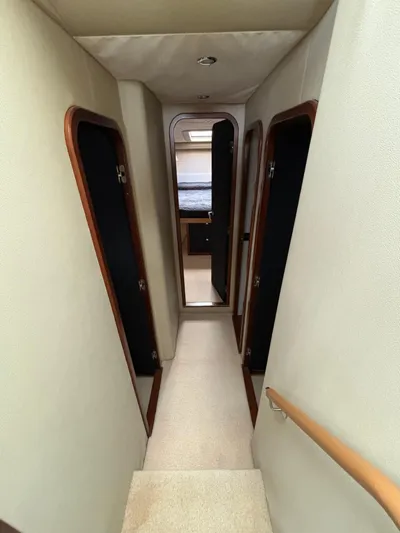  Yacht Photos Pics Interior hallway of 2010 Princess 62 Flybridge yacht with cabin doors.