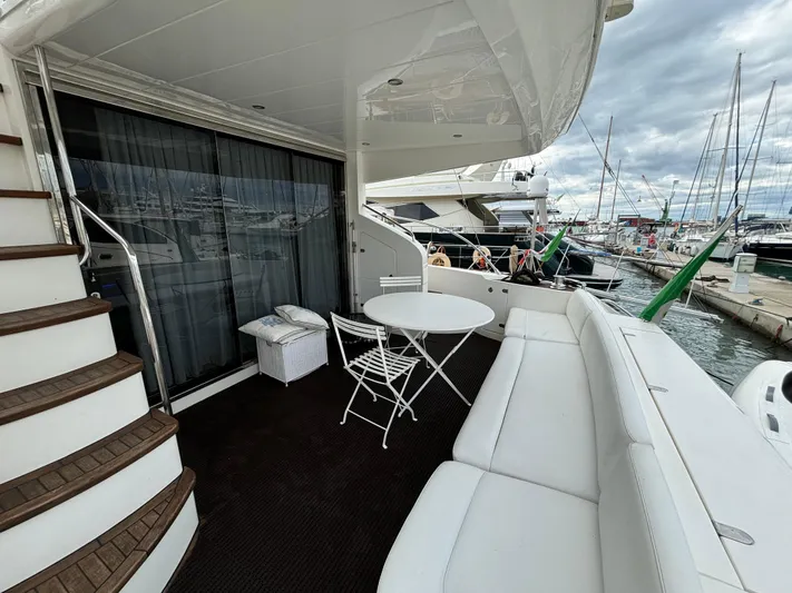  Yacht Photos Pics Luxurious 2010 Princess 62 Flybridge yacht with elegant seating and marina view.