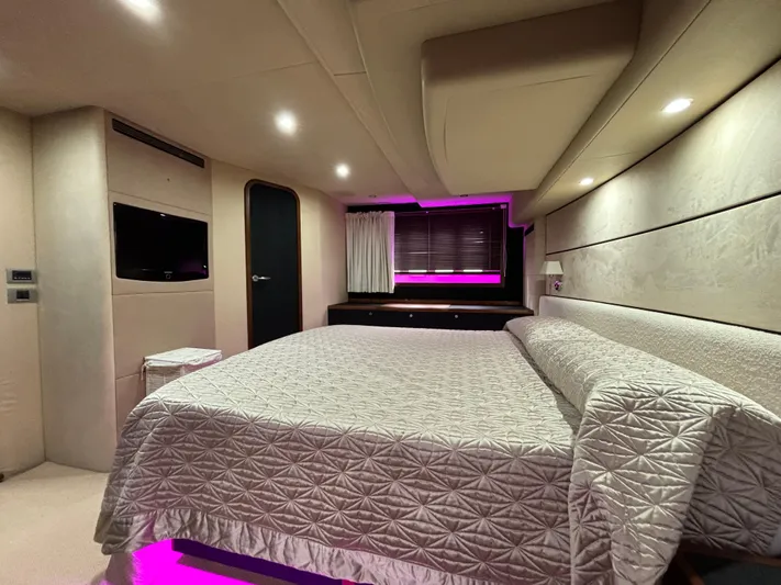  Yacht Photos Pics Luxurious bedroom interior of 2010 Princess 62 Flybridge yacht with ambient lighting.