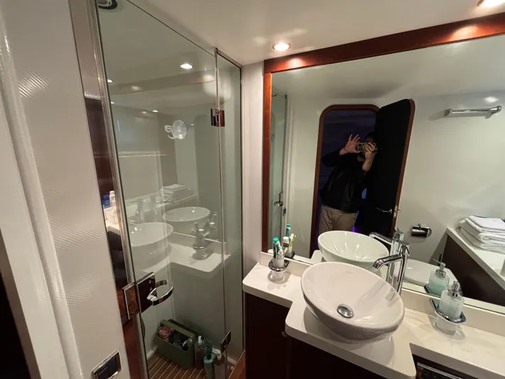  Yacht Photos Pics Luxurious bathroom in 2010 Princess 62 Flybridge yacht with modern fixtures and glass shower.
