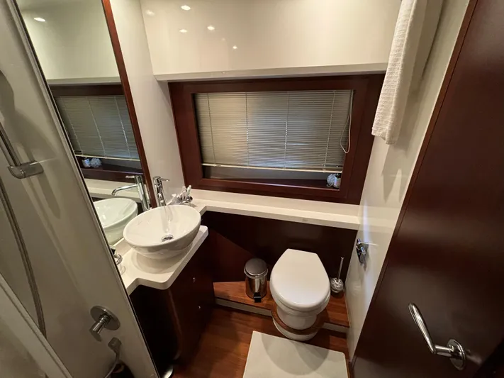  Yacht Photos Pics Luxurious bathroom in a 2010 Princess 62 Flybridge yacht, featuring modern fixtures and wood accents.