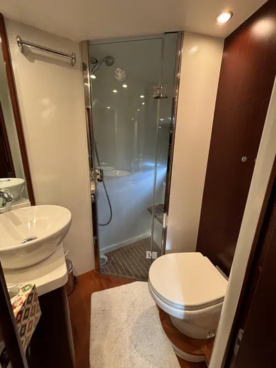  Yacht Photos Pics Luxurious bathroom in 2010 Princess 62 Flybridge yacht with modern fixtures and glass shower.