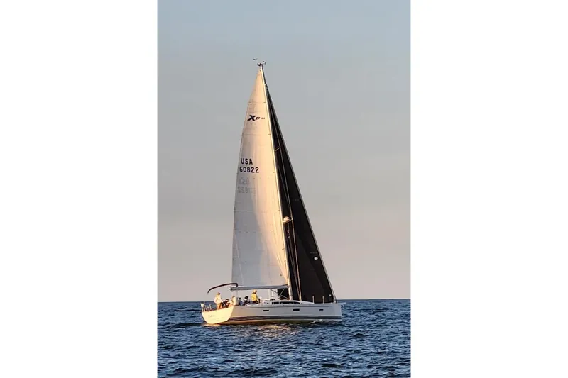  Yacht Photos Pics 2016 X-Yachts XP-44 sailing on open water at sunset.