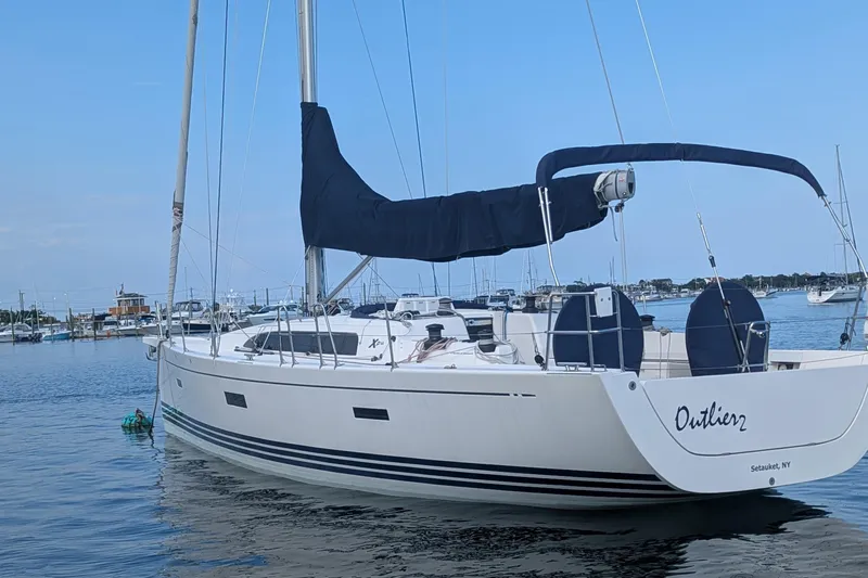  Yacht Photos Pics 2016 X-Yachts XP-44 sailboat docked in a serene marina setting.