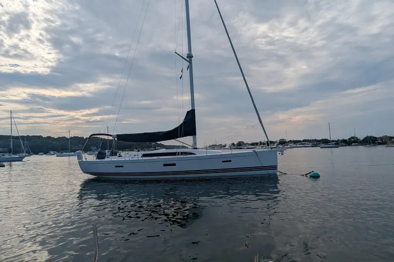 Yacht Photos Pics 2016 X-Yachts XP-44 sailboat anchored in a serene harbor at sunset.