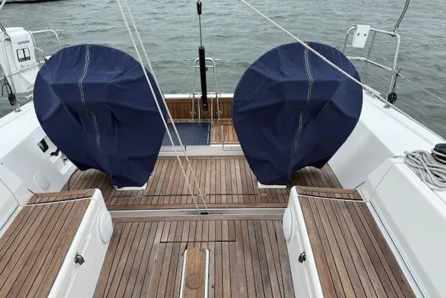  Yacht Photos Pics 2016 X-Yachts XP-44 sailboat cockpit with covered wheels, teak decking, and ocean backdrop.