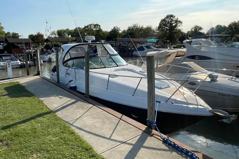  Yacht Photos Pics 2019 Rinker 370 EX yacht docked at a marina on a sunny day.