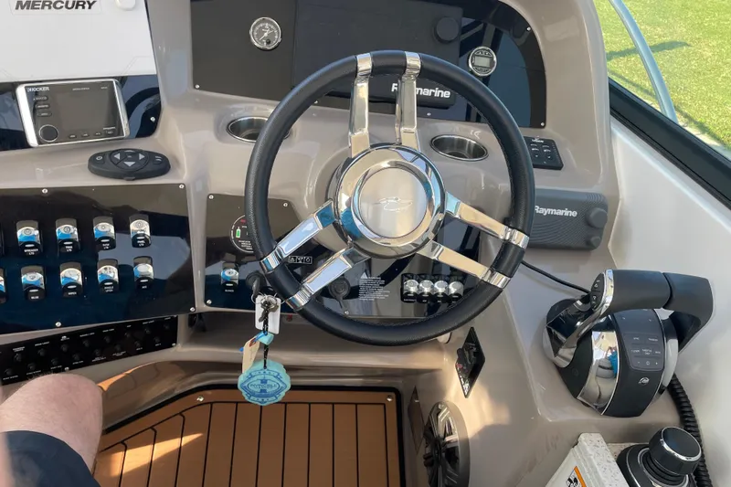  Yacht Photos Pics 2019 Rinker 370 EX boat dashboard with steering wheel and control panel.