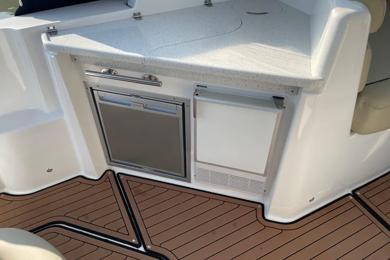  Yacht Photos Pics 2019 Rinker 370 EX boat interior with kitchenette and wood-style flooring.
