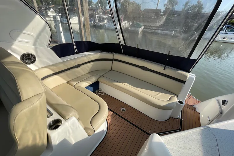  Yacht Photos Pics 2019 Rinker 370 EX boat interior with beige seating and wood flooring.