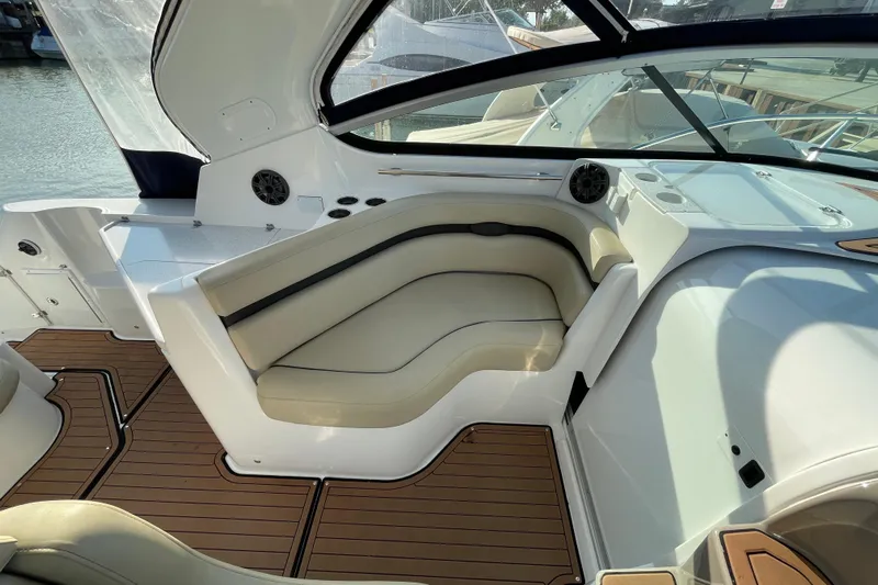  Yacht Photos Pics 2019 Rinker 370 EX boat interior with beige seating and wood flooring.