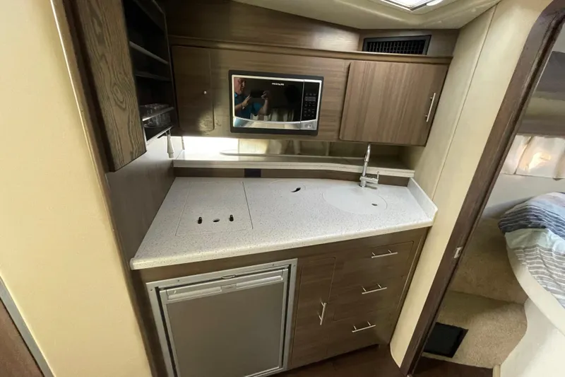  Yacht Photos Pics 2019 Rinker 370 EX yacht kitchen with modern appliances and sleek cabinetry.