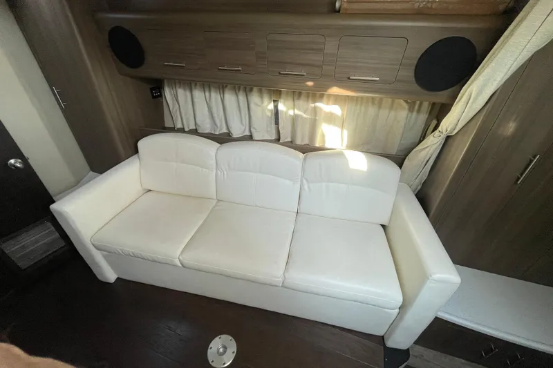  Yacht Photos Pics White sofa in 2019 Rinker 370 EX cabin with wooden cabinets and curtains.