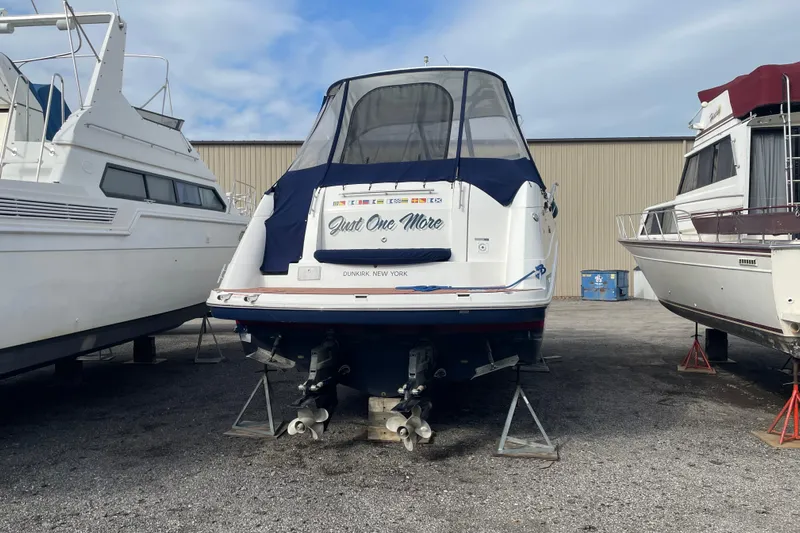  Yacht Photos Pics 2019 Rinker 370 EX boat on stands, rear view, in a boatyard.