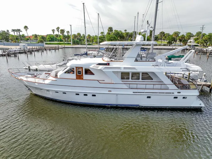 Seaeo Yacht Photos Pics Elegant 1985 Lowland 68 Neth Ships yacht docked in a serene marina setting.