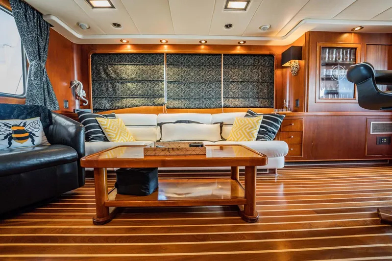 Seaeo Yacht Photos Pics Luxurious yacht interior with wooden flooring, elegant seating, and decorative accents, Lowland 68 Neth Ships, 1985.