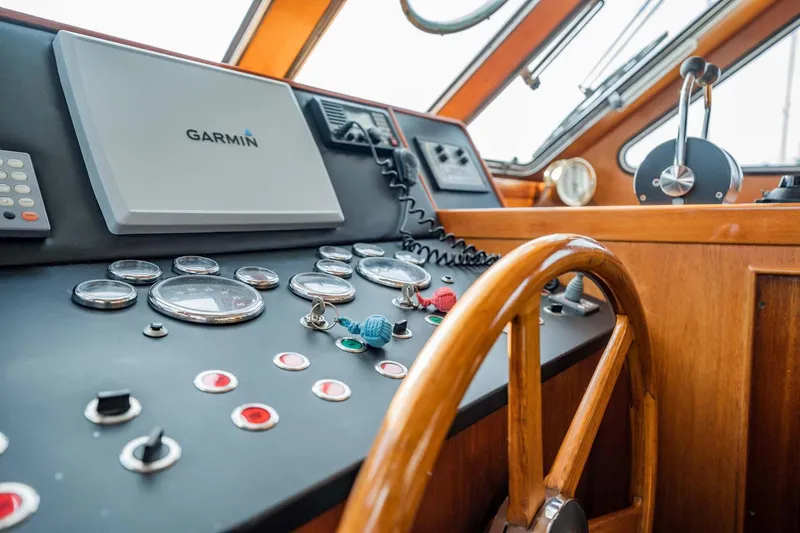 Seaeo Yacht Photos Pics Control panel of 1985 Lowland 68 Neth Ships with wooden steering wheel and navigation instruments.