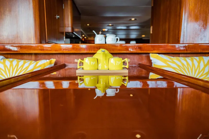 Seaeo Yacht Photos Pics Luxurious yacht interior with yellow teapot, wooden table, and decorative cushions, Lowland 68 Neth Ships.