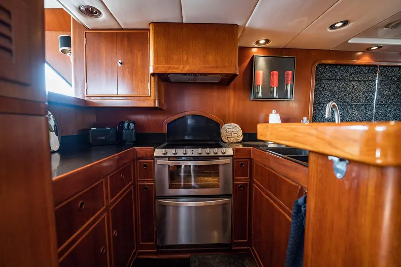 Seaeo Yacht Photos Pics Luxurious wooden kitchen interior on a 1985 Lowland 68 Neth Ships yacht.