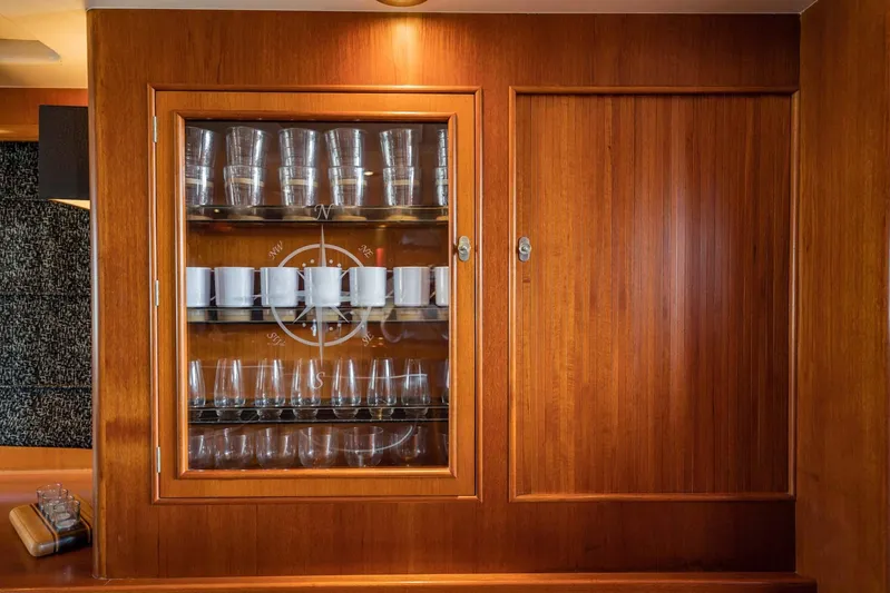 Seaeo Yacht Photos Pics Wooden cabinet with glassware on a 1985 Lowland 68 Neth Ships yacht.
