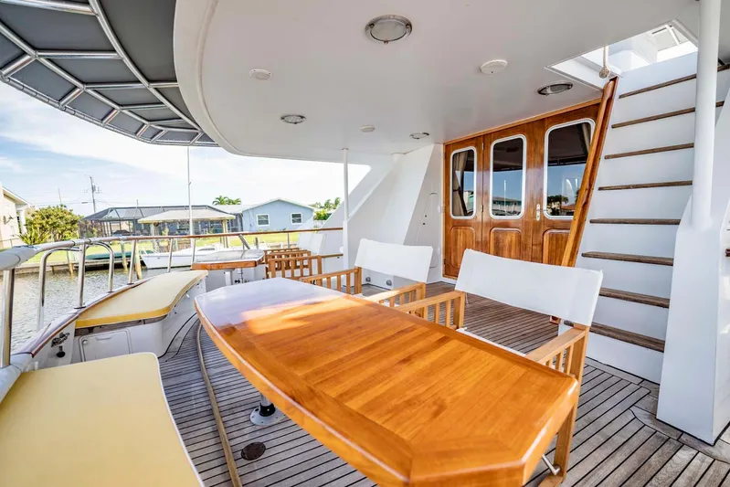 Seaeo Yacht Photos Pics Outdoor deck of 1985 Lowland 68 Neth Ships yacht with wooden furniture and stairs.