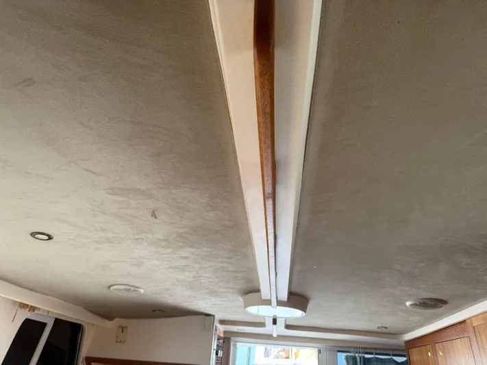 Real Therapy Yacht Photos Pics Ceiling view inside 2001 Mainship 390 Trawler, featuring recessed lighting and wood accents.