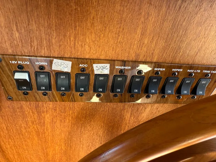 Real Therapy Yacht Photos Pics Control panel of a 2001 Mainship 390 Trawler with labeled switches.
