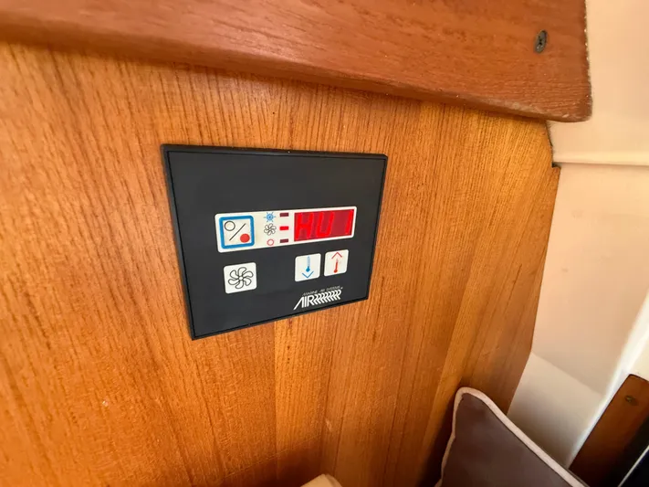 Real Therapy Yacht Photos Pics Control panel on 2001 Mainship 390 Trawler, mounted on wooden interior wall.